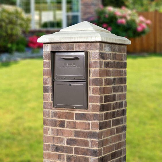 Rich bronze locking mailbox installed in brick